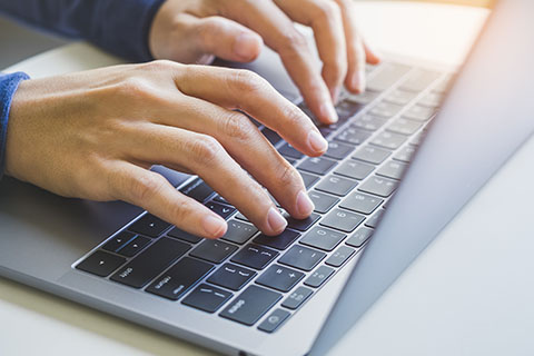 picture of hands typing on a laptop